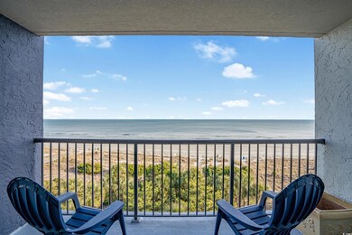 Balcony with a beach view and a water view