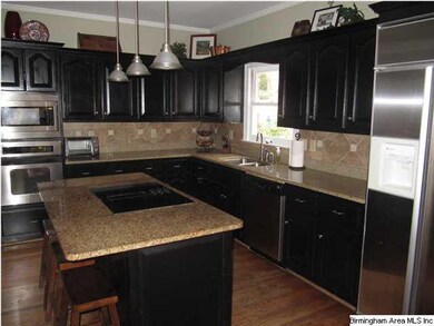 Updated kitchen with granite, custom tile backspla