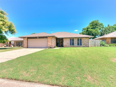 Ranch-style house with a garage and a front lawn