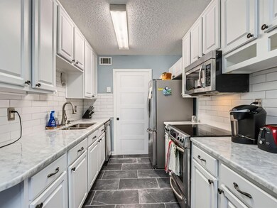 Kitchen featuring visible vents, appliances with s