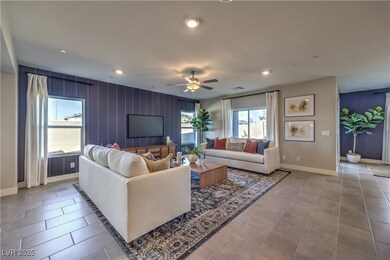 Living area featuring ceiling fan, recessed lighting, and light tile patterned floors