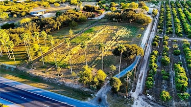 Aerial view of sparsely populated area featuring rows of crops