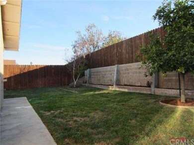 Back yard is fully fenced and features a full pati