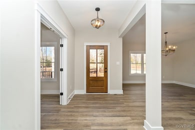 Entrance foyer featuring baseboards, a notable cha