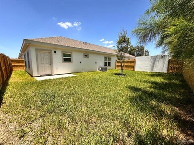Rear view of property with a fenced backyard, stucco siding, and a patio