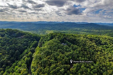 View of mountain backdrop featuring a forest