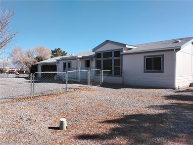 Front view featuring fence and a gate