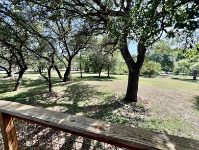 View of green lawn with view of scattered trees