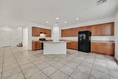 Kitchen featuring light countertops, black refrige