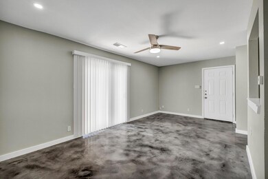 Empty room featuring ceiling fan, baseboards, and