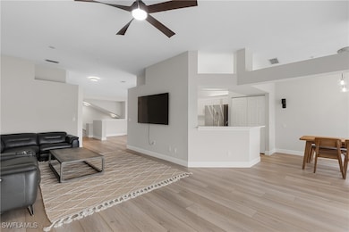 Living room featuring a towering ceiling, light ha
