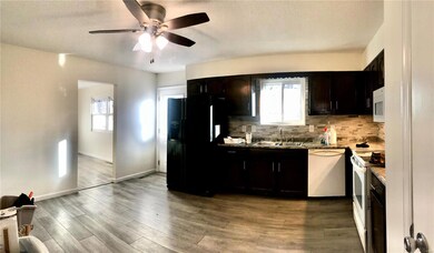 Kitchen with refrigerator, dishwasher and range.