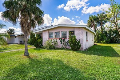 View of side of property featuring a yard