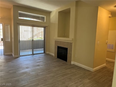 Unfurnished living room featuring wood finished floors and a fireplace