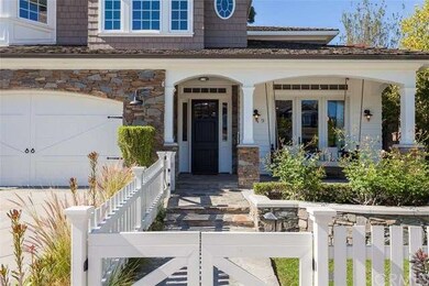 Covered porch seating & lush landscaping