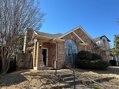 View of front of property with a gate and brick si