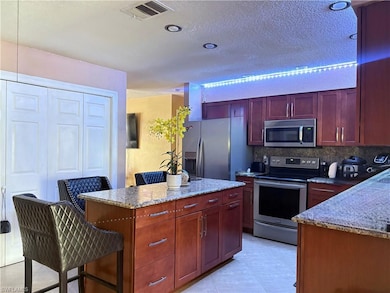 Kitchen featuring light tile patterned floors, sta