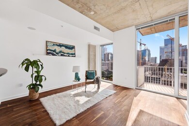 Living area featuring a skyline view, wood finish