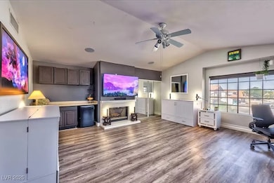 Living area with a ceiling fan, lofted ceiling, wo