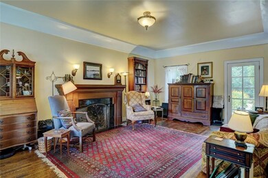 Front living area with wood floors and fireplace.