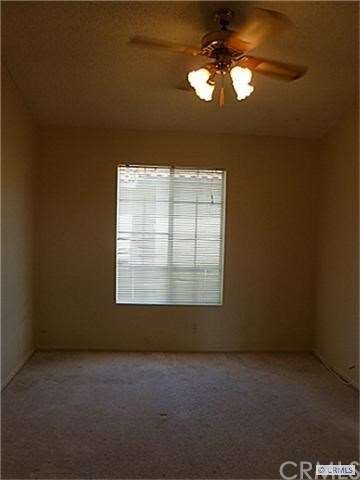 Bedroom with vaulted ceiling, ceiling fan & light