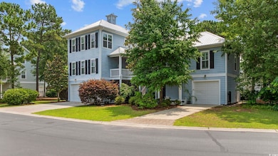 View of front of house featuring driveway, an attached garage, and a front lawn