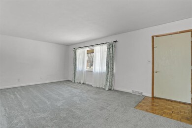  Step into a generously sized, light-filled living room.