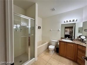 Full bathroom featuring toilet, tile patterned flo