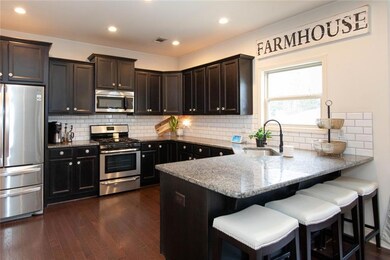Kitchen with visible vents, a sink, appliances wit