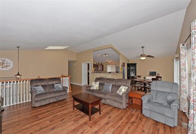 wide open floor plan with cathedral ceiling and gorgeous wood floors
