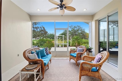 Covered, Screened Side Porch that Overlooks the Patio Surrounded by a Garden & Arbor with Open Views of Common Property Owned by the HOA