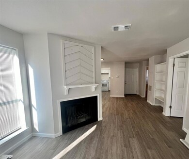 Unfurnished living room featuring a fireplace and dark wood-style floors