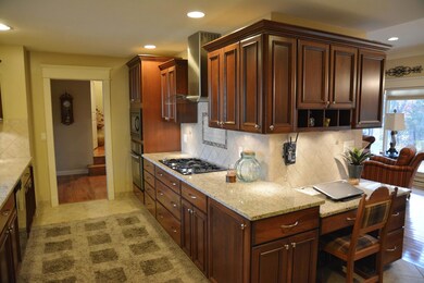Galley kitchen w/ custom walnut cabinets