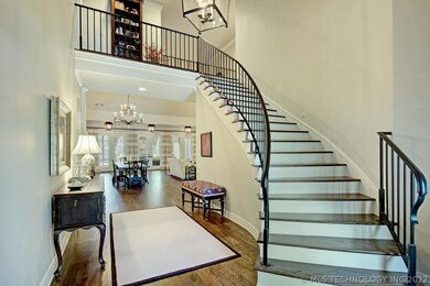 A sweeping staircase with custom railing in the en