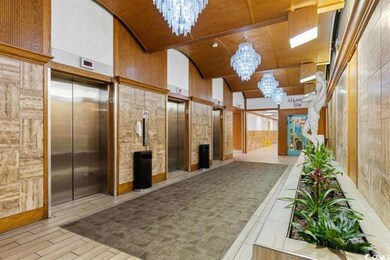 Building lobby featuring lofted ceiling, wood ceiling, and wood walls