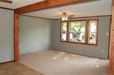 LIVING ROOM OPEN TO KITCHEN. NEW CARPET/FAN/PAINT.
