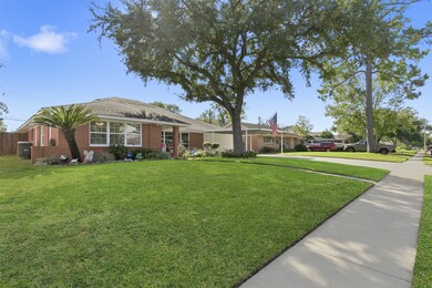Charming single-story brick home with a well-maintained front yard featuring lush grass, mature trees, and a welcoming walkway. Ideal for those seeking a cozy, inviting neighborhood atmosphere.