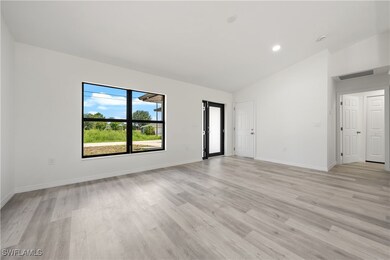 Spare room featuring light wood-type flooring, hig