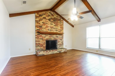 Unfurnished living room featuring wood finished fl