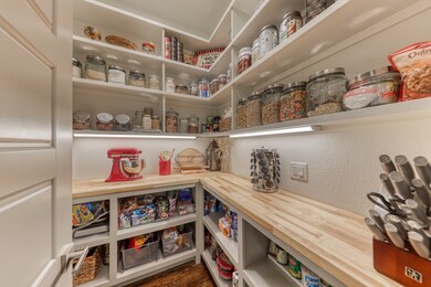 Custom pantry with open cabinets and custom shelving