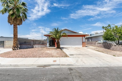 Single story home with a garage, driveway, and bri