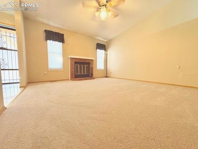 Unfurnished living room with carpet floors, a fireplace, ceiling fan, and vaulted ceiling