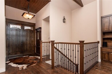 Substantial Wooden Double Front Doors lead to the Stunning Detailwork of the Staircase and down to Walk-out Basement