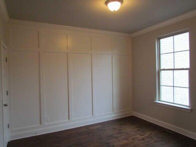 FIRST FLOOR OFFICE WITH WALL DETAIL, DOUBLE DOORS, AND A STORAGE CLOSET.