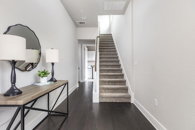 Stairway with wood finished floors, baseboards, a