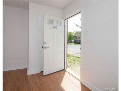The front entrance freshly painted door with windows and coat closet.