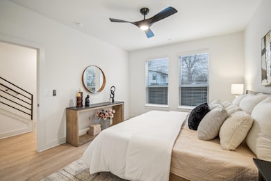 Bedroom with light wood-style floors, baseboards,