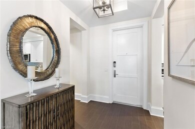 Entryway featuring a chandelier, baseboards, and w