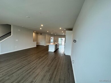 Unfurnished living room featuring recessed lighting, a sink, baseboards, and dark wood-type flooring