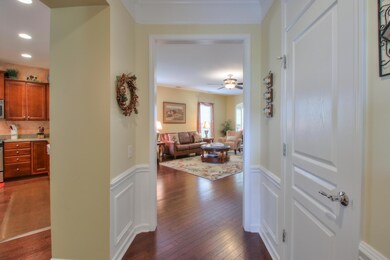 Foyer with decorative wainscoting trim and beautiful hardwood floor. 